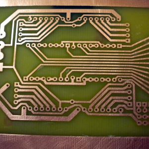 I etched this board by printing a mask onto transparencies, and then using those transparencies over a photosensitive board.  The etching solution was