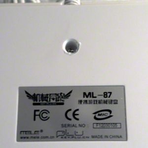 Close up of the label and the one screw to remove separate the top and bottom sections of the case. It was covered by a small, round sticker. There ar