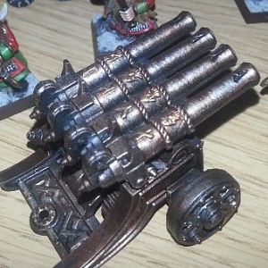 bronzed organ gun with gold detailing.